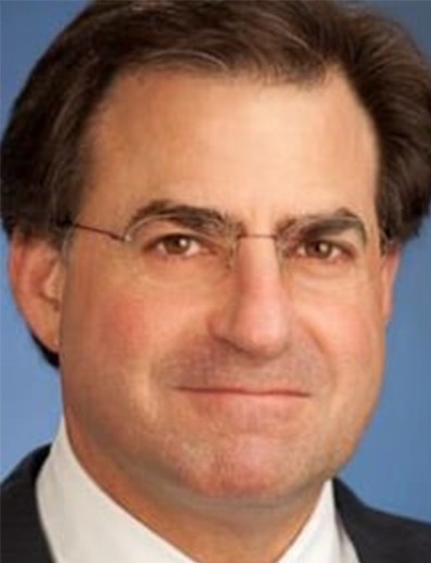 Male employee smiles for camera